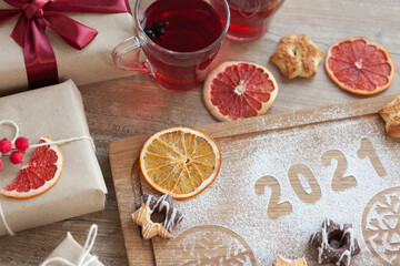 Christmas and New Year 2021 background with ingredients for cooking christmas baking decorated with fir tree. New Year's decor, homemade cookies preparing for the holiday.