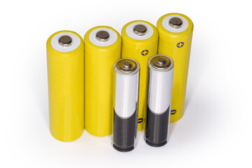 Rechargeable AA batteries and alkaline AAA batteries on white background