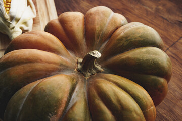 One whole pumpkin on wooden table background