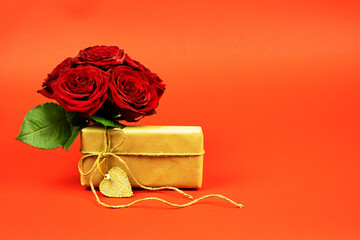  Bouquet of red roses with craft paper box on red background