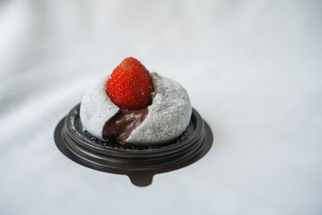Chocolate Strawberry Daifuku. A Japanese traditional dessert, stuffed with dark chocolate cream and topped with fresh strawberry. white background.