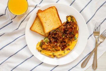 Homemade Denver Omelette on a white plate on cloth, top view. Flat lay, overhead, from above.