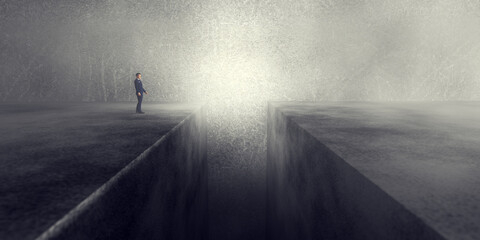 Businessman standing in front of precipice or a gap