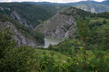 Fototapeta na wymiar Scenic canyon view of meanders on the river Uvac, on the Zlatar Mountain,with beautiful sky in the background.Uvac is a special nature reserve in Serbia with endangered bird species Griffon Vulture.