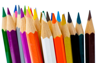 A stack of pencils in many different colors. Studio photo isolated on grey background.