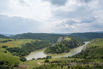 Scenic canyon view of meanders on the river Uvac, on the Zlatar Mountain,with beautiful sky in the background.Uvac is a special nature reserve in Serbia with endangered bird species Griffon Vulture.