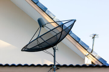 Satellite dish and antenna on the roof house.