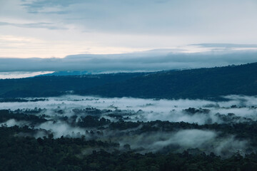morning mist cover the forest villages between mountains with cloudy orange sunrise sky
