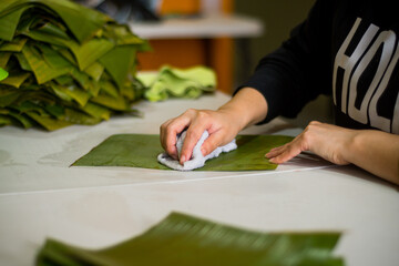 Cleaning banana leaves to make tamales