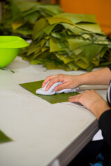 Cleaning banana leaves to make tamales
