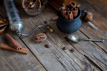 Still life of cinnamon sticks, coffee grains on a wooden table. Copy space.