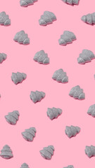 Christmas pattern layout made with shiny silver trees on pastel pink background. Minimal New year celebration concept. Flay lay, top view.