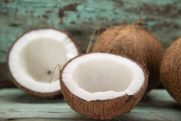 Dried coconut fruits in natura on aged wooden background