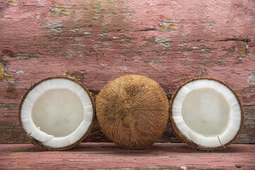 Dried coconut fruits in natura on aged wooden background