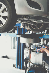 Fototapeta premium motor oil container for filling old engine oil from car in garage