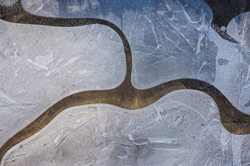 Natural winter abstract background, frozen water with bizarre patterns, macro image