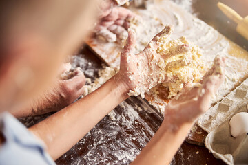 Little chef hands covered in baking mixture