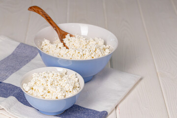 Bowl of cottage cheese on wooden table
