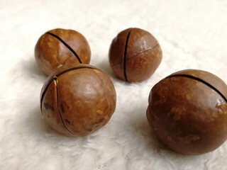 Macadamia nuts on a grey fabric