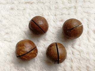 Macadamia nuts on a grey fabric