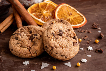 Organic food snack tasty sweet dessert milk dark chocolate chip salt cookie closeup piece fruit orange raspberry hazelnut nuts cinnamon on cocoa cacao powder wooden table for new year Christmas gift