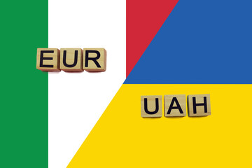 Italy and Ukraine currencies codes on national flags background