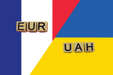France and Ukraine currencies codes on national flags background