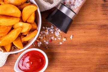 Tradition french fries from organic bio potato wedges with skin dip in ketchup