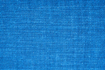 Linen dense fabric pattern of blue color for curtains design or internal wall decoration of a modern building with vibrant shiny material. High quality photo