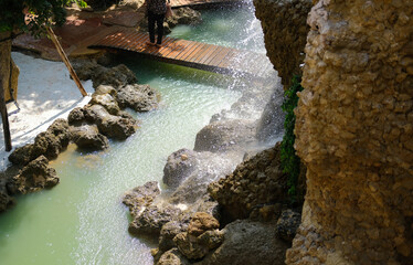 bridge and manmade waterfall park. flowing water stream