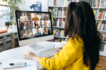 Multiracial business people gathered together in online video conference talk discuss financial...