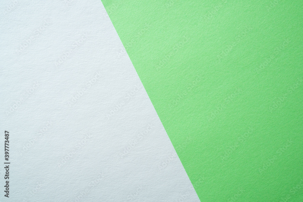 Wall mural beautiful paper background of two parts white and light green. sheets of blank white and light green