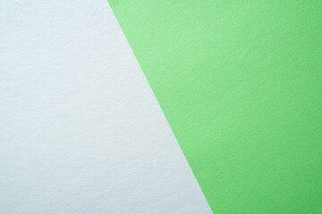 Beautiful paper background of two parts white and light green. Sheets of blank white and light...