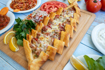 Traditional turkish baked dish pide. Turkish pizza pide, Middle eastern appetizers. Turkish cuisine. Top view. Pide with meat filling.