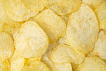 Natural salted potato chips background.