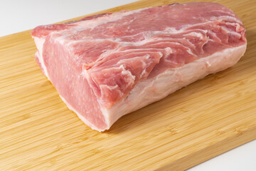 Pork loin or pork chop on cutting board. Juicy and tender pork meat.