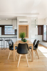 Wooden table with black chairs