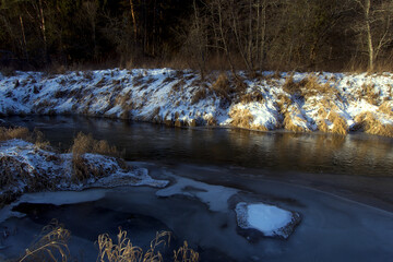 Winter landscape in the frozen day near river. Early morning.