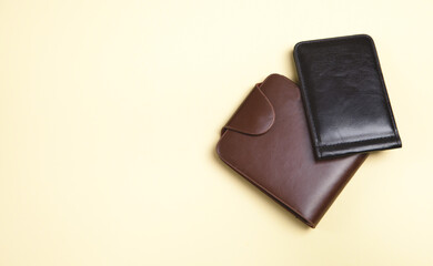 Men's wallets on an isolated yellow background.