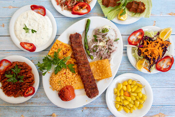 in the plate with the hot kebab and appetizers. adana kebab. top wiev