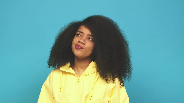 Young african american curly woman confused, feels doubtful and unsure