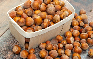 Hazelnuts in  small crate on rustic background