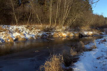 Winter landscape in the frozen day near river. Early morning.