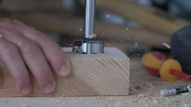 Forstner drill with wood filings slow motion macro footage.Joiner's workshop and woodworking