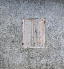 Gray plaster wall with old vintage window