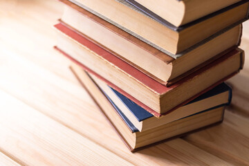 Stack of old books on wooden table. Home library. Storybooks collection. Learning and education concept. Classic literature.