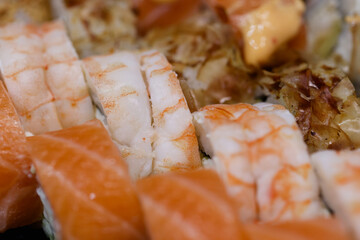 Delicious chinese cuisine rolls and seafood sushi close up.
