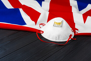 Fototapeta premium Medical mask on flag of United Kingdom