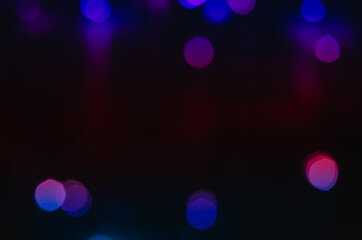 Abstract pattern of blue bokeh lights on black background