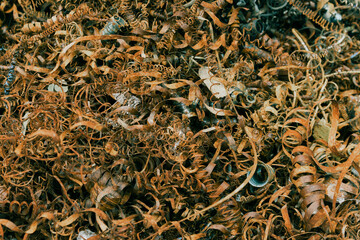 Close-up of twisted spiral steel shavings, non-ferrous scrap for recycling.